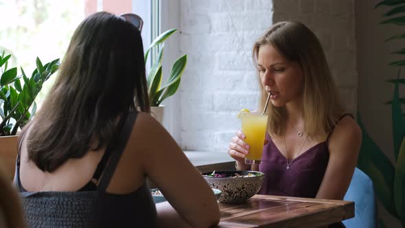 Attractive Women Friends Having Lunch at Cafe