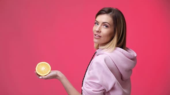 Smiling Beautiful Blonde Caucasian Woman Holding Oranges