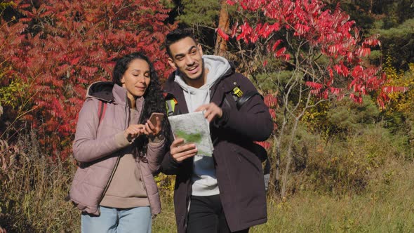 Happy Young Couple in Love Hiking Tourists Backpacking Outdoors Talking Discussing Arguing Guy Looks