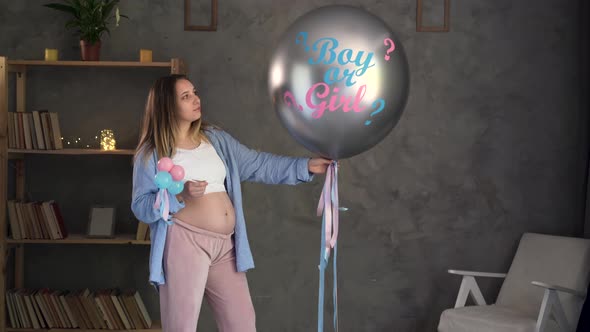 Big Balloon with the Words Girl or Boy Baby Gender Disclosure Party Pregnant Woman with Belly Baby