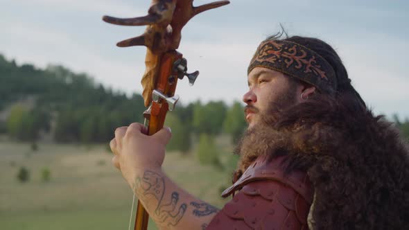 Obese Bearded Guy in Leather Clothes Plays Ikili at Fest