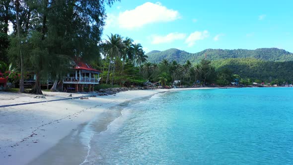 Natural overhead island view of a sandy white paradise beach and turquoise sea background in colourf