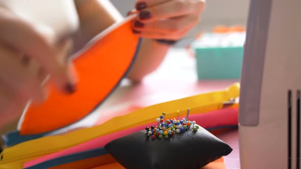 Woman Cuts Thread on Detail of Future Bag at Workplace