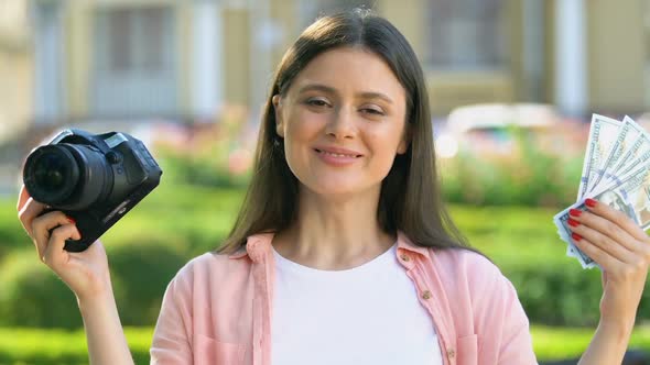 Happy Female Photographer Holding Camera and Dollars, Hobby Earning, Income