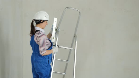 Female Worker Inspecting Room to Renovate