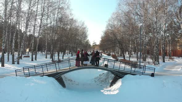 Russian Folklore - People in Russian Costumes Are Dancing on the Bridge in Winter