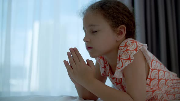Little Girl is Praying in Her Room