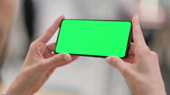 Female Watching Smartphone with Green Chroma Key Screen