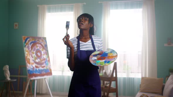 Portrait of Black Woman Playing with Painting Tools
