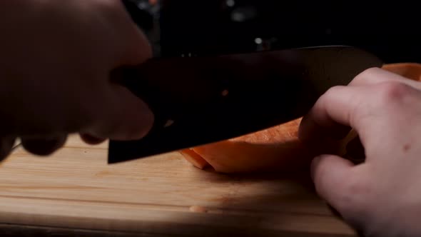 Cutting a sweet potato.