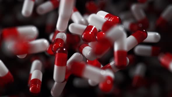 Pills fly after being exploded. Slow Motion.