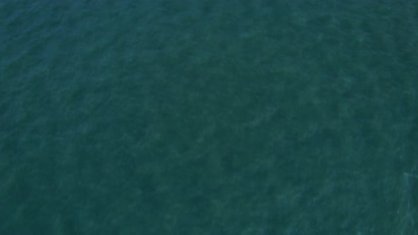 4K Aerial view of drone move on beautiful sea. Flight over ocean, open sea. Dynamic aerial shot.