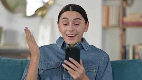 Latin Woman Celebrating on Smartphone