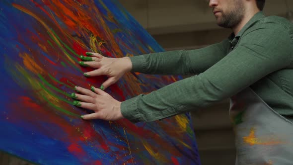 Male Artist Draws a Picture with His Hands