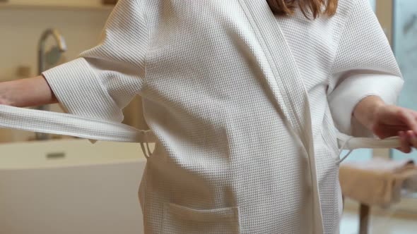 Slender Young Woman Taking Off Her Robe to Take a Relaxing Bubble Bath