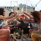 Cheerful multi-ethnic friends laughing and toasting with cocktails at rooftop - VideoHive Item for Sale