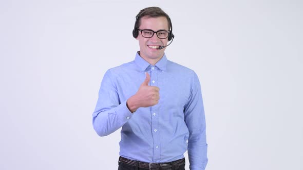 Young Happy Handsome Businessman As Call Center Representative Giving Thumbs Up