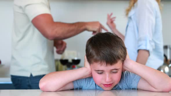 Little Boy Blocking Out Noise from Parents Fighting