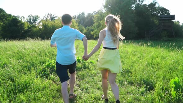 Two People Are Running Across the Field