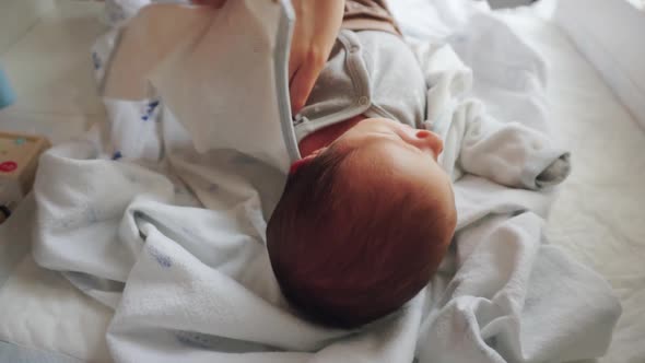 A Newborn Lies on a Changing Table