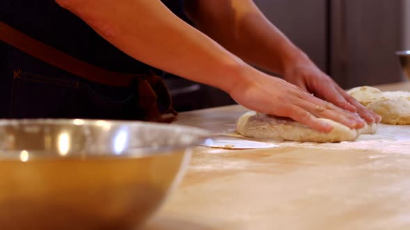 Chef preparing dough on the table
