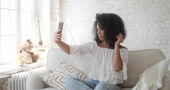 Trendy Happy Mixed Race Woman Vlogger Posing and Recording Videostream Video for Social Media