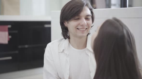 Carefree Young Woman Whispering on Ear of Smiling Man, Boyfriend Kissing Girlfriend on Forehead