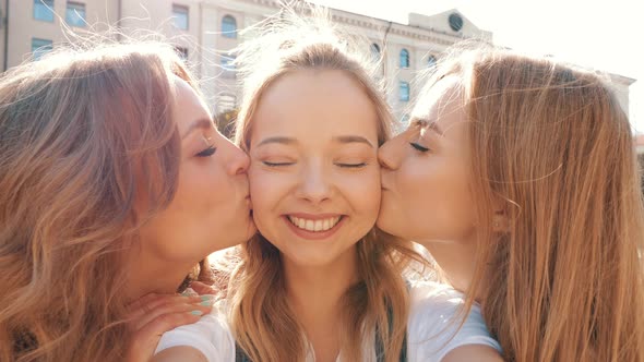 Three young female hipster friends posing outdoors