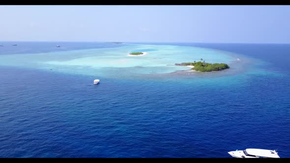 Aerial travel of perfect tourist beach vacation by blue green lagoon with white sandy background of 