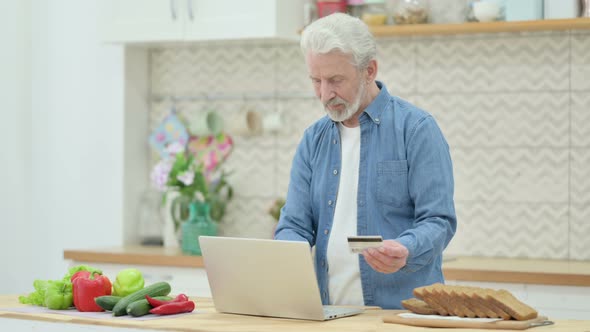 Old Couple Making Online Payment on Laptop