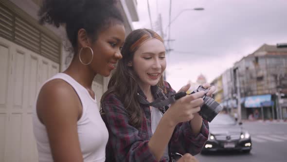 Two girlfriends are enjoying a walk in the city.