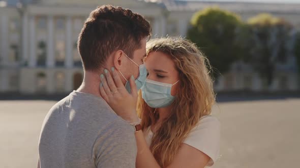 Social Distancing Together During Quarantine. Young Couple Kissing Outdoor Wearing Protective