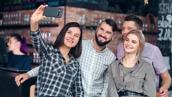 Happy Young Friend Having Fun Posing for Photo Using Mobile Phone Relaxing During Party