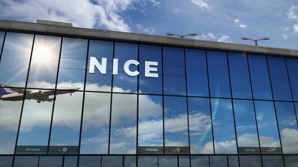 Airplane landing at Nice France airport mirrored in terminal