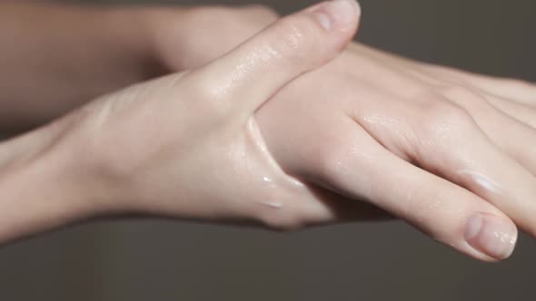 A Young Woman Puts on Her Hands a Cream, a Natural Skin Care Product