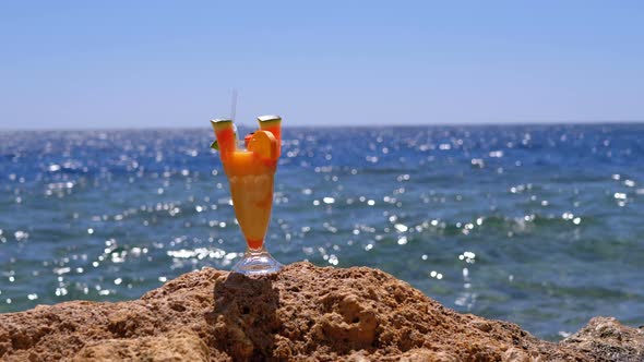 Exotic Cocktail in Glass Stands on the Reef Beach on the Background of Red Sea. Egypt