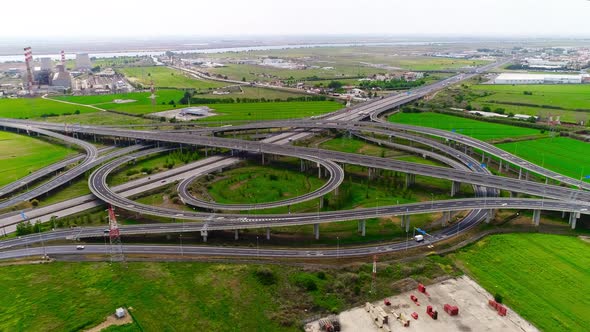 Freeway Road with Moving Cars Between Green Fields