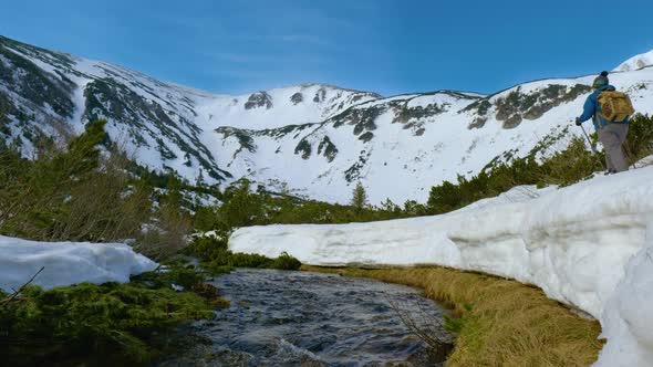 Young Woman with a Backpack Travels in the Mountains