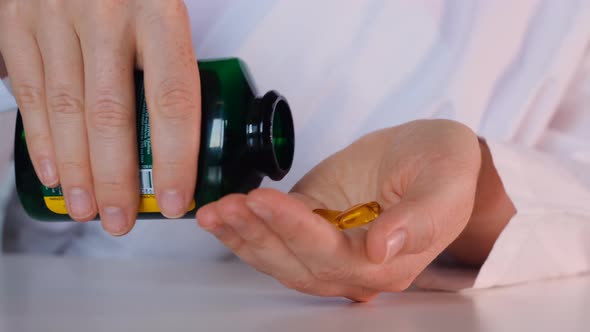 Hand Female Doctor Lays Out Put Yellow Pills in Hand
