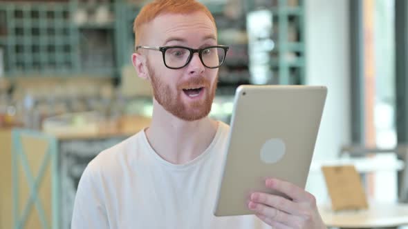 Portrait of Vide Chat on Tablet By Redhead Man