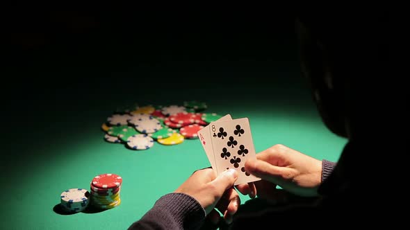 Male Gambling Addict Playing Poker at Illegal Casino, Taking Risk to Lose Money