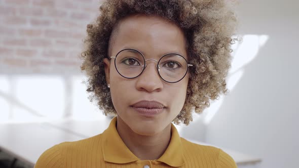 Portrait of Pretty Female Office Worker in Glasses Standing and Looking to Camera