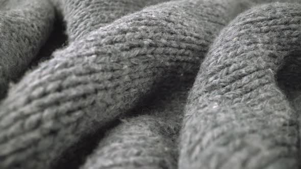 Extreme detail view of sheep wool cloth texture flowing in macro dolly shot.