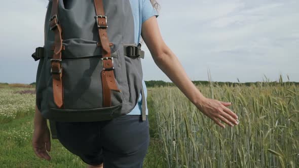 Woman Traveler Walking in The Field with Spikelets