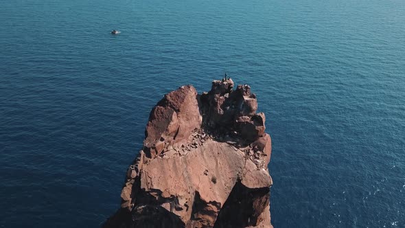 Aerial View on High Rock in Mediterranean Sea Against Horizon. Blue Sky. Flying Birds. Lipari