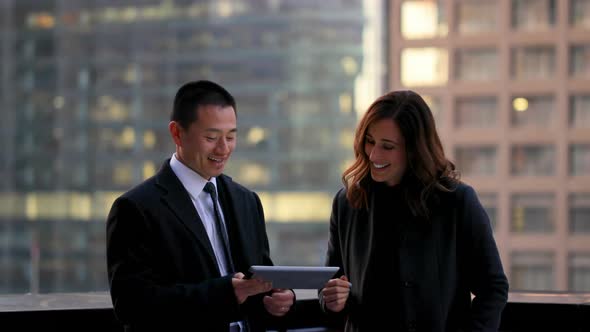 Front view of mixed race business people discussing over digital tablet 4k