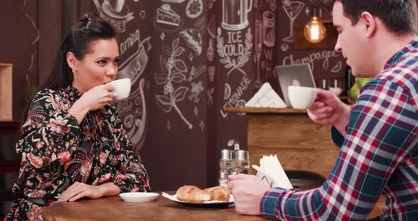 Happy In-love Couple Drinking Their Morning Coffee in the City