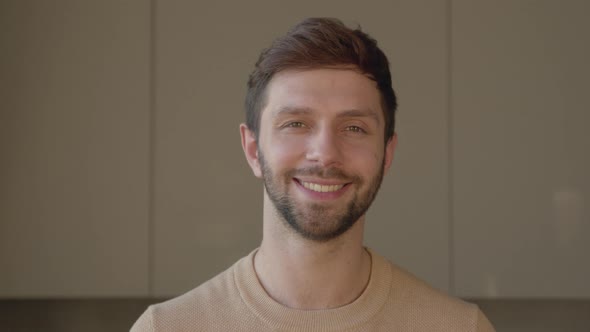 Portrait of a smiling man looking at camera, slow motion concept
