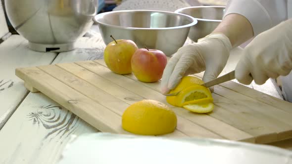 Chef in Gloves Cutting Fruits