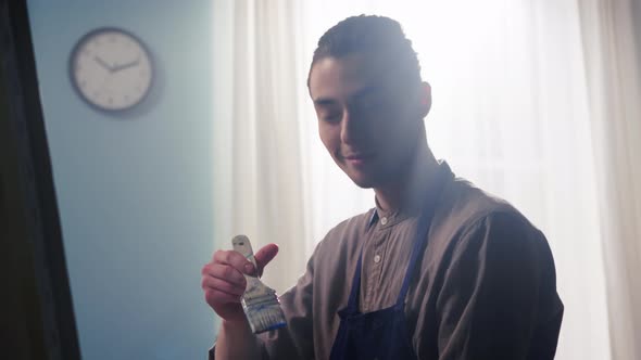 Portrait of Young Man Artist In Counter Light